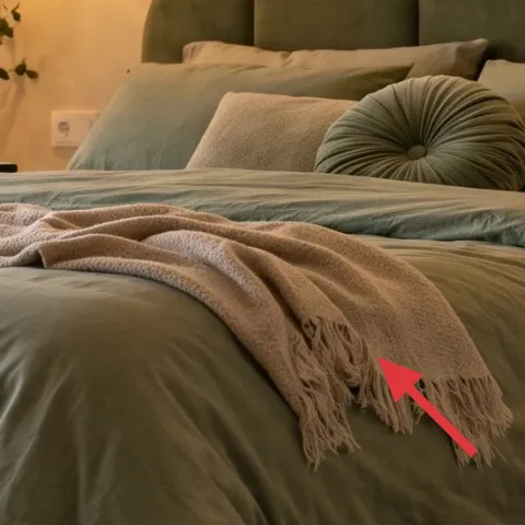 tan throw blanket on bed